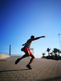 Full length of woman jumping in mid-air