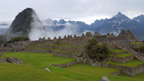 Scenic view of mountain against cloudy sky