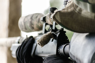 Close-up of army soldier holding rifle