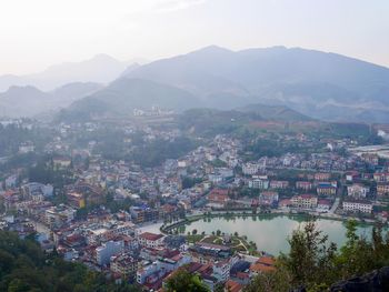 High angle view of townscape and mountains against sky