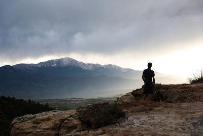 Man standing on mountain against sky