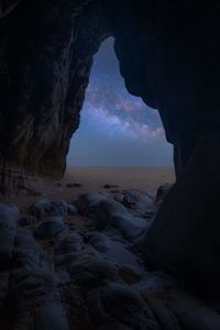 Scenic view of sea seen through cave