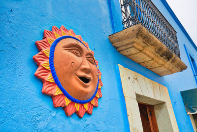 Low angle view of smiling painting on building wall