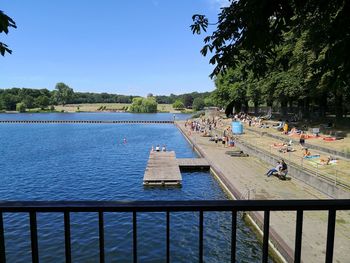 People at swimming pool against sky