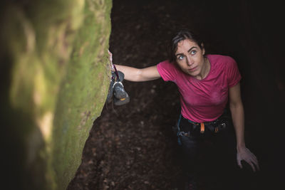 High angle view of woman preparing for rock climbing