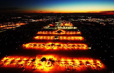 Illuminated city against sky at night