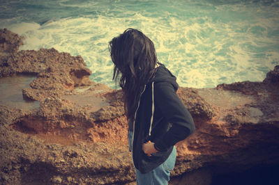 Side view of woman standing on beach