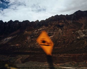 Blurred motion of road sign against mountains