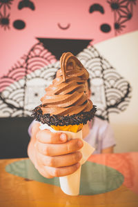 Midsection of person holding ice cream cone