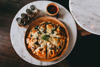 High angle view of pizza served on table