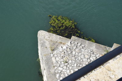 High angle view of rocks on pier over lake