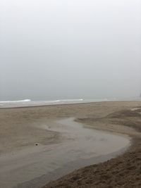 Scenic view of beach against clear sky