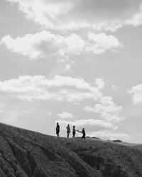 People standing on land against sky