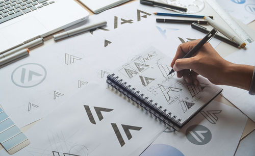 High angle view of hand working on table