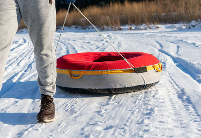Low section of man standing on snow