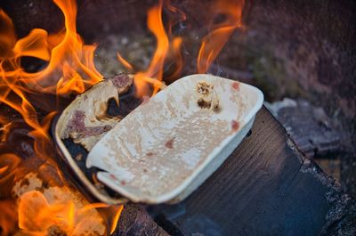 Close-up of burning candles on wood