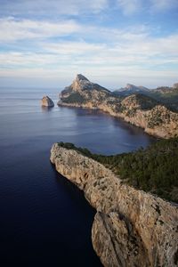 Scenic view of sea and mountains against sky