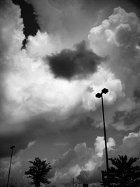Low angle view of street light against cloudy sky