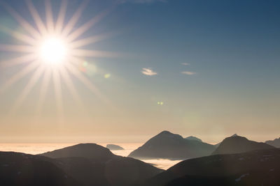 Scenic view of mountains against sunny sky