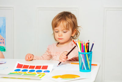 Boy drawing on book