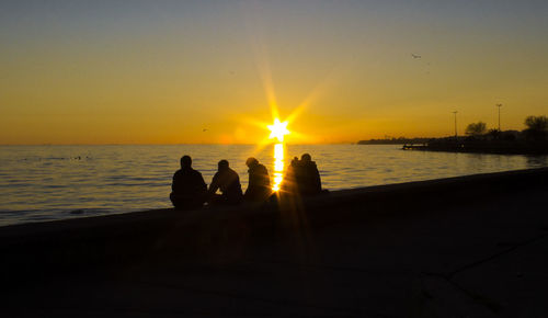 Silhouette of people at sunset