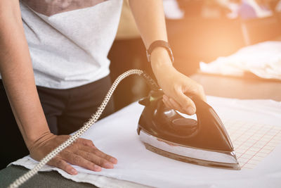 Midsection of woman working on table