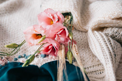 Close-up of pink rose flower and wheat background