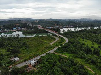 High angle view of buildings and trees against sky