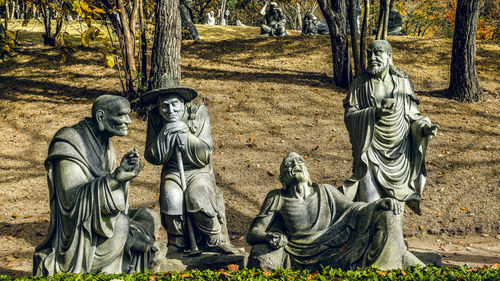 Statue of buddha against trees