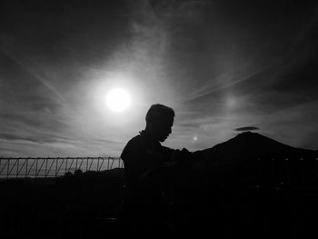 The silhouette man in the dark light