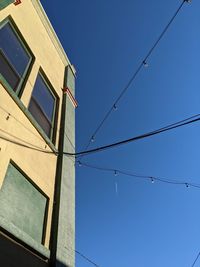 Low angle view of cables against clear sky