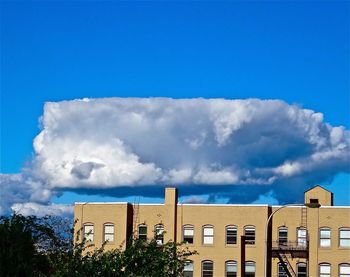 Low angle view of building against blue sky