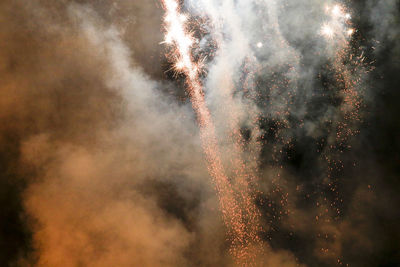 Low angle view of firework display at night