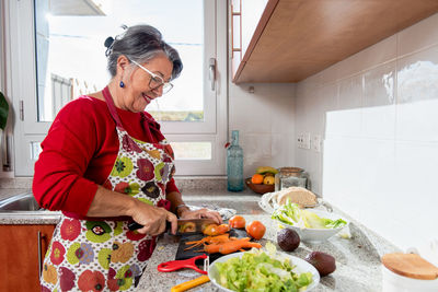Midsection of woman preparing food in kitchen