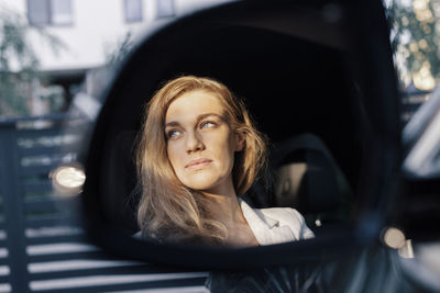 Portrait of beautiful woman in car