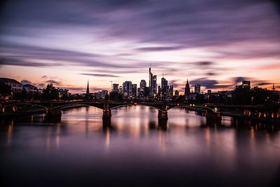 View of bridge over river at night