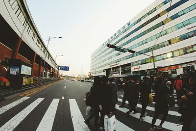 People on road in city against clear sky