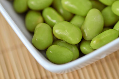 High angle view of green fruits in bowl on table