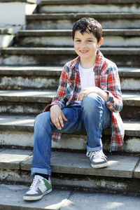 Portrait of boy sitting on steps