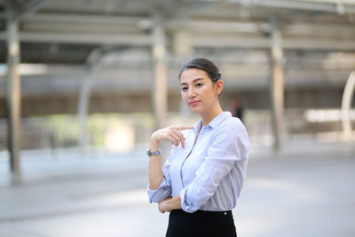 Portrait of young woman standing outdoors