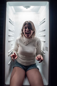 Portrait of a smiling young woman standing at home
