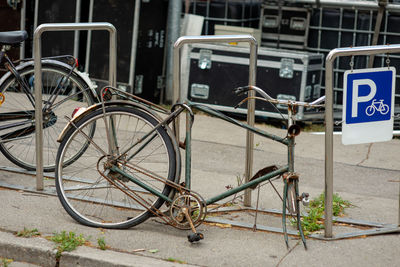 Bicycles parked on racks at sidewalk