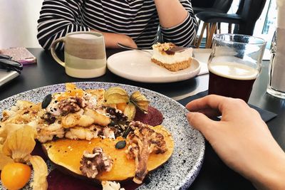 Midsection of man having breakfast on table