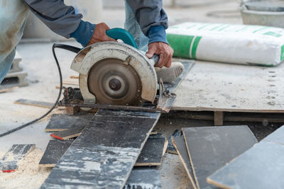 Worker use circular saw cutting plywood for make formwork pour cement.construction site.