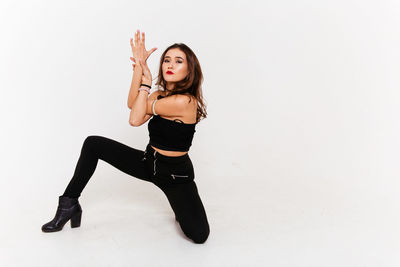 Portrait of young woman against white background