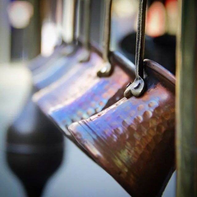 focus on foreground, close-up, metal, selective focus, indoors, still life, table, metallic, no people, empty, absence, day, wood - material, single object, part of, man made object, rusty, old, in a row, detail