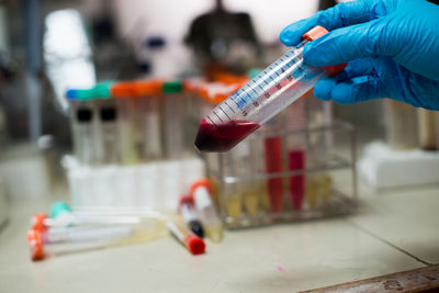 Cropped hand examining in laboratory