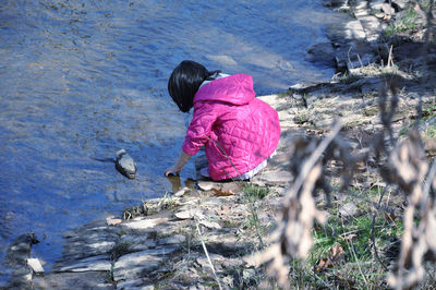 High angle view of girl by creek