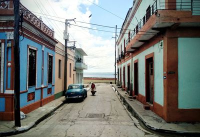 Cars on street amidst buildings in city