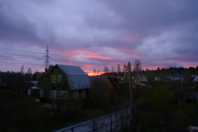 Silhouette trees against sky at sunset
